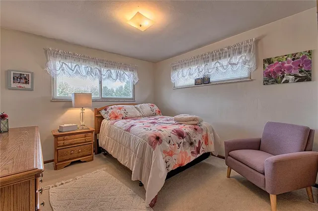 a bedroom with a bed couch and window