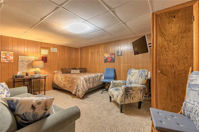 a bedroom with furniture and a large window