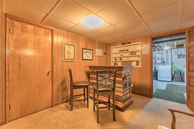 a dining room with furniture and a floor to ceiling window