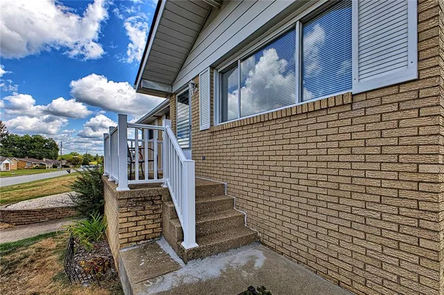 a view of balcony with wooden floor and fence