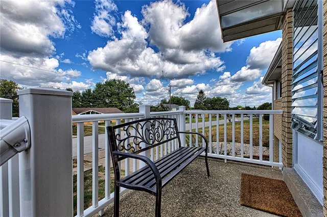 a view of a house with a yard and sitting area