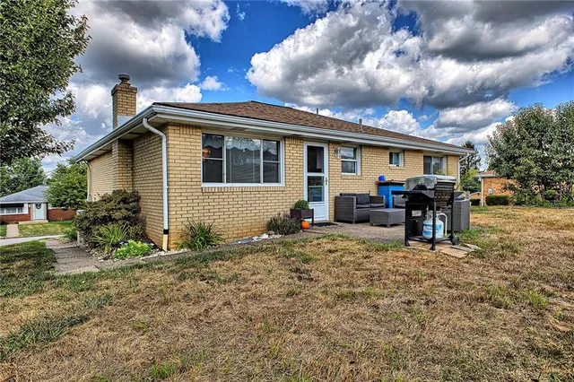 a front view of house with a garden and patio