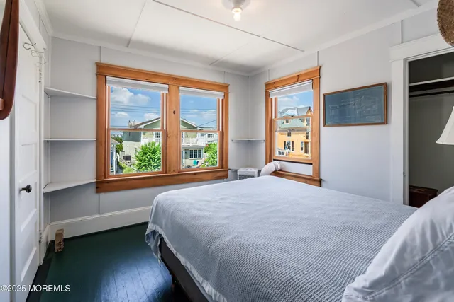 a bedroom with a large bed and a large window