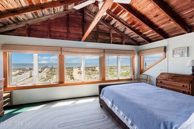 a bedroom with a large bed and a large window with outer view