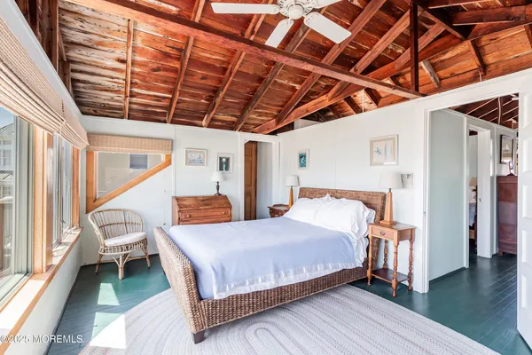 a bedroom with a bed next to a window