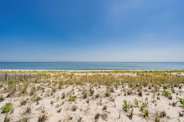 a view of white house with a yard