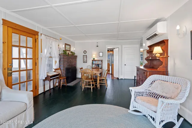 a living room with furniture a flat screen tv and a large window