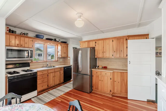 a kitchen with granite countertop stainless steel appliances and wooden cabinets