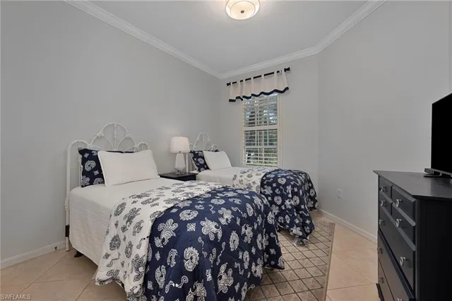 a bedroom with a bed and a television