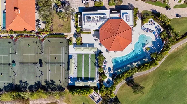 an aerial view of a house with a yard and potted plants