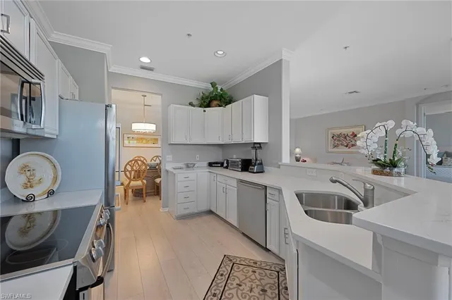 a kitchen that has a lot of cabinets and refrigerator