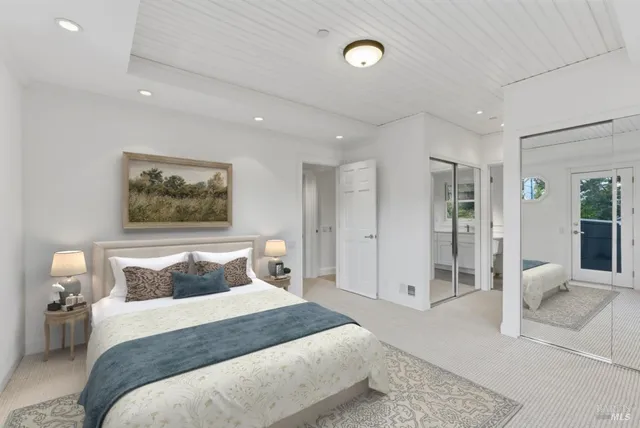 a bedroom with a bed and a painting on the wall