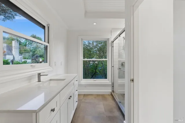 a bathroom with a double vanity sink a mirror and a bathtub