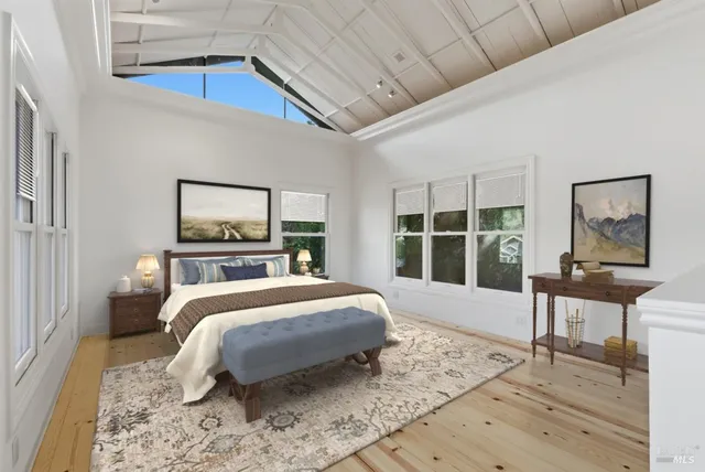 a bedroom with a bed a table and chair