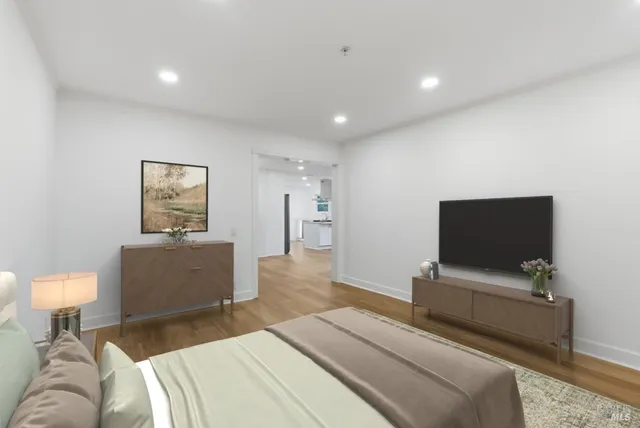 a bedroom with a bed and a flat screen tv