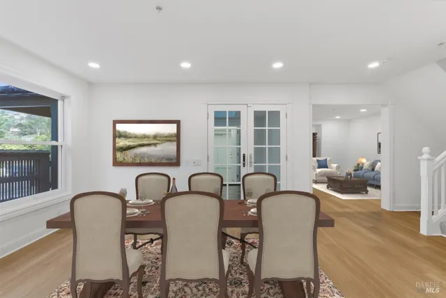 a dining room with furniture and wooden floor