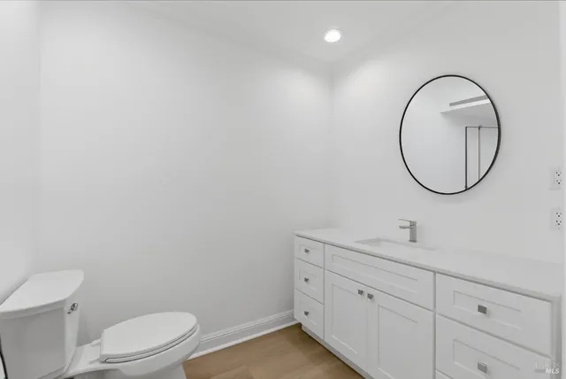 a bathroom with a toilet a sink and a mirror