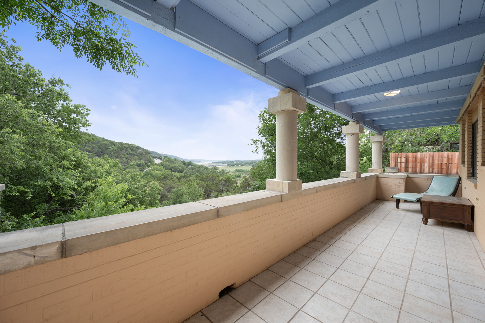 a view of a patio with a table and chairs