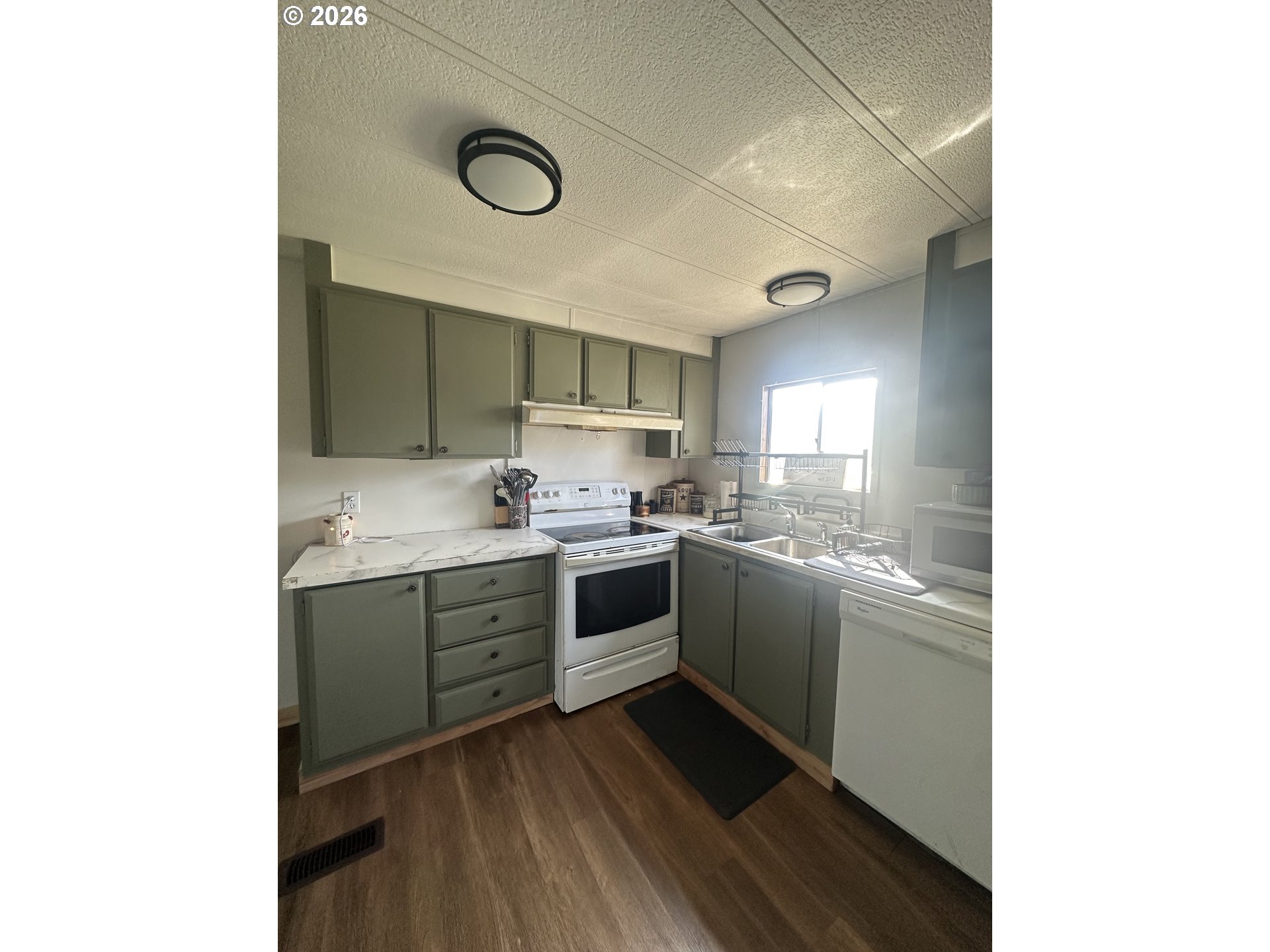 355 North 8th Street Lakeside, OR 97449 - Photo 12 of 22 a kitchen with a sink and cabinets