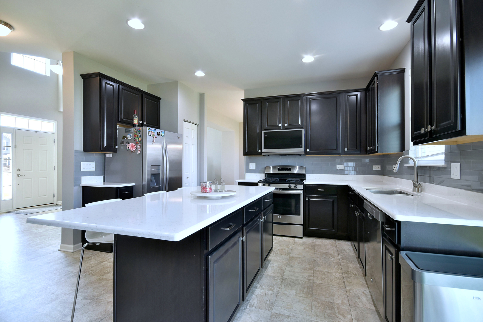 168 Reston Lane Gilberts, IL 60136 - Photo 15 of 43 a kitchen with stainless steel appliances granite countertop a sink stove top oven and refrigerator