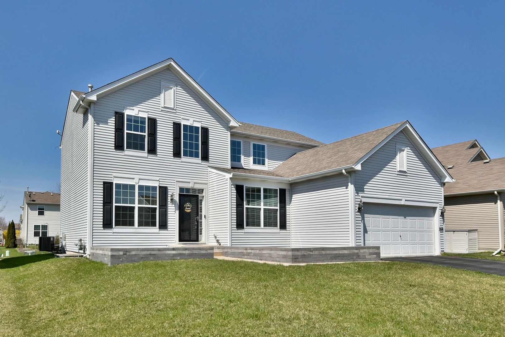 168 Reston Lane Gilberts, IL 60136 - Photo 2 of 43 a front view of a house with a yard