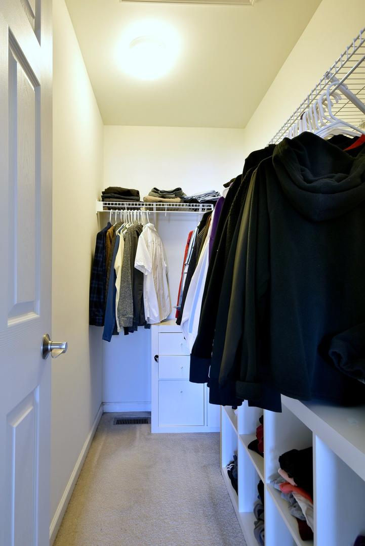 168 Reston Lane Gilberts, IL 60136 - Photo 33 of 43 a view of walk in closet with clothes and shoes