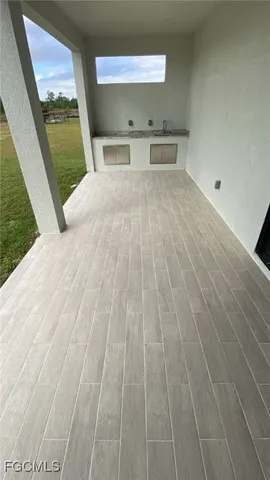 a view of a room with wooden floor and a rug