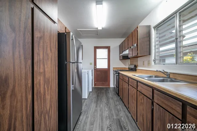 a kitchen with stainless steel appliances granite countertop a refrigerator and a sink