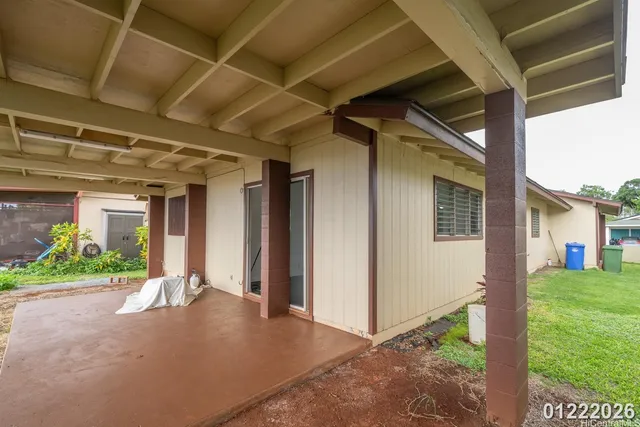 a view of a porch with furniture and garden