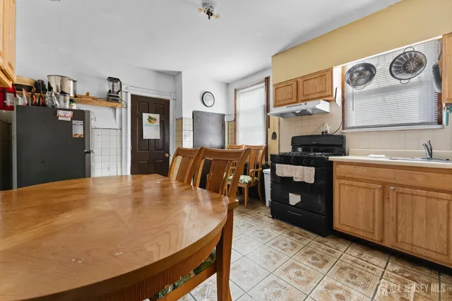a kitchen with stainless steel appliances granite countertop a sink a stove and refrigerator