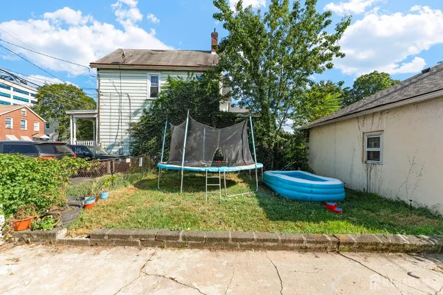 a wooden bench sitting in front of a house