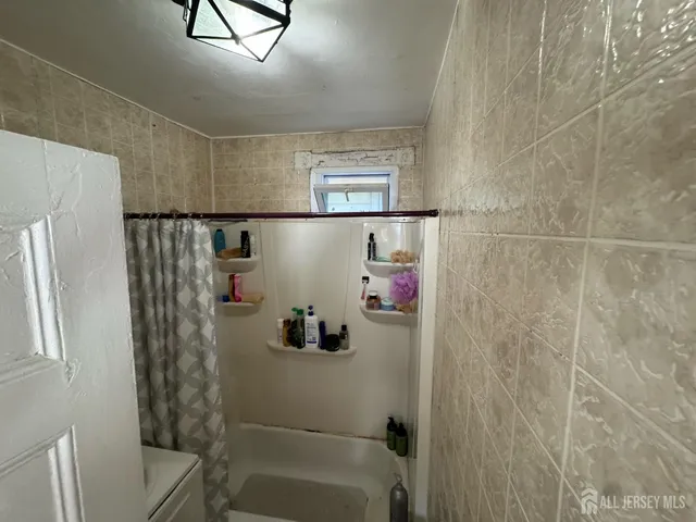 a bathroom with a shower and a sink