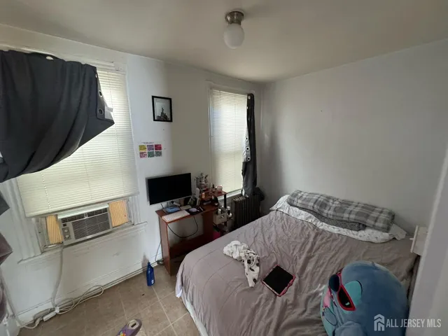 a bedroom with a bed and flat screen tv