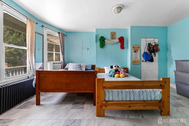 a bedroom with a bed and a window