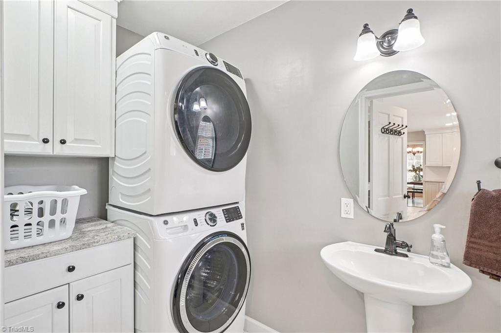 1412 Hobbs Road Greensboro, NC 27408 - Photo 14 of 47 Convenient Main level Laundry space w/folding shelf + Cabinetry