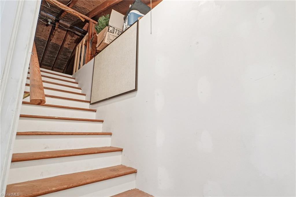 1412 Hobbs Road Greensboro, NC 27408 - Photo 23 of 47 Permanent stairs lead to a HUGE floored attic space
