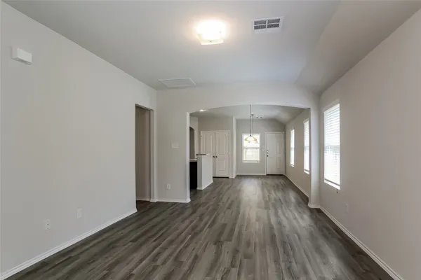 a view of a room with wooden floor and window