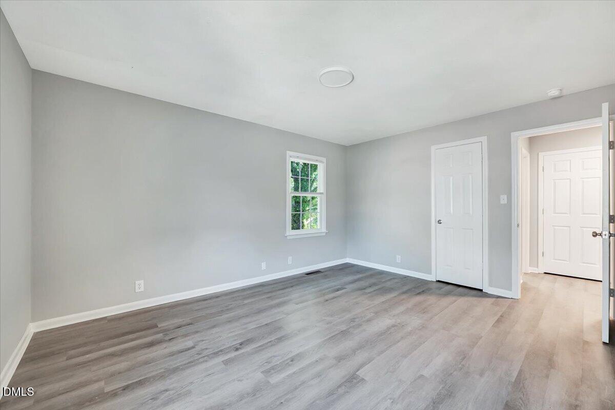 3408 Atlantic Avenue Raleigh, NC 27604 - Photo 37 of 48 an empty room with wooden floor and windows