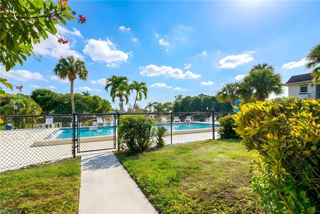 5579 Rattlesnake Hammock Road, Unit B9 Naples, FL 34113 - Photo 17 of 20 a view of a park with swings and slides