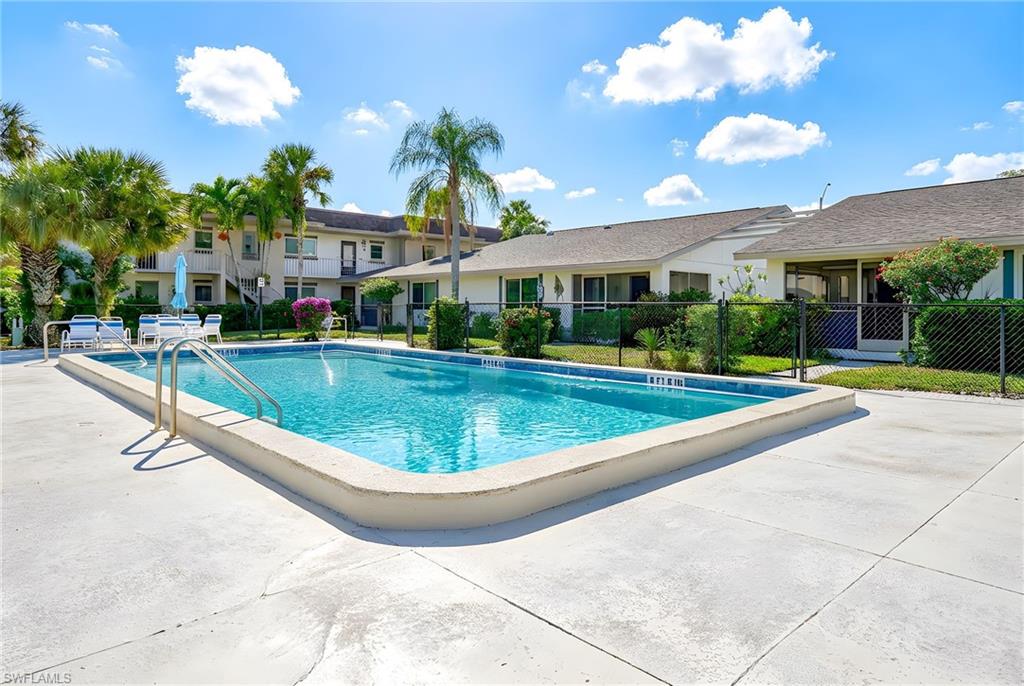5579 Rattlesnake Hammock Road, Unit B9 Naples, FL 34113 - Photo 18 of 20 a view of a swimming pool with a fountain