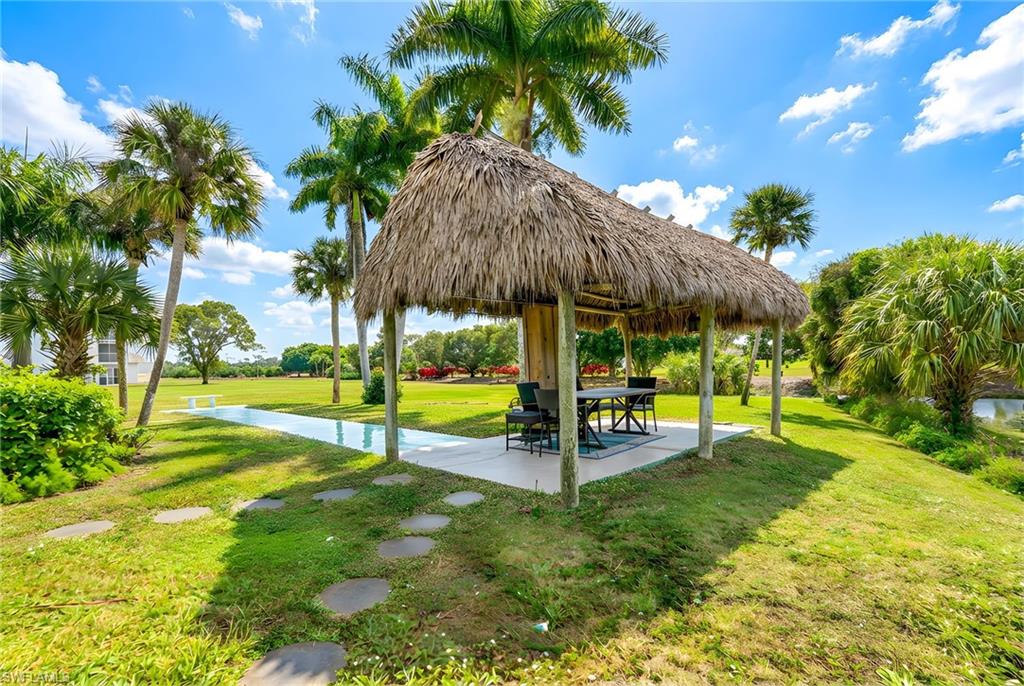 5579 Rattlesnake Hammock Road, Unit B9 Naples, FL 34113 - Photo 19 of 20 a view of a house with swimming pool and a yard