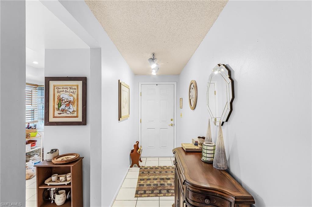 5579 Rattlesnake Hammock Road, Unit B9 Naples, FL 34113 - Photo 2 of 20 a room with gym equipment and mirror