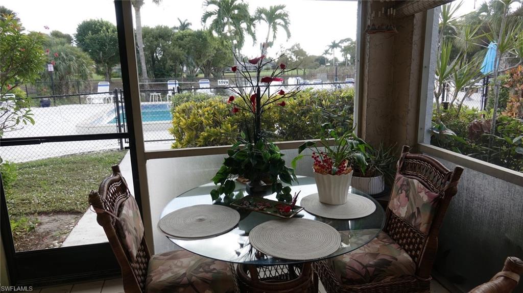 5579 Rattlesnake Hammock Road, Unit B9 Naples, FL 34113 - Photo 2 of 9 Peaceful view of pool, lake and golf course