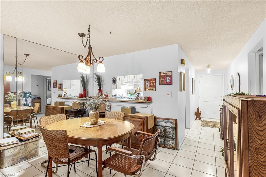 5579 Rattlesnake Hammock Road, Unit B9 Naples, FL 34113 - Photo 3 of 20 a view of a dining room with furniture