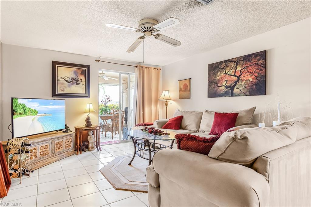 5579 Rattlesnake Hammock Road, Unit B9 Naples, FL 34113 - Photo 8 of 20 a living room with furniture and a flat screen tv