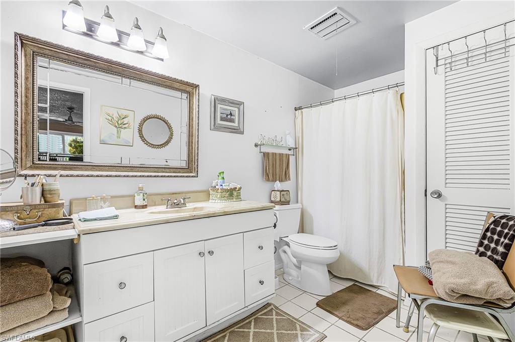 5579 Rattlesnake Hammock Road, Unit B9 Naples, FL 34113 - Photo 10 of 20 a spacious bathroom with a sink toilet and shower