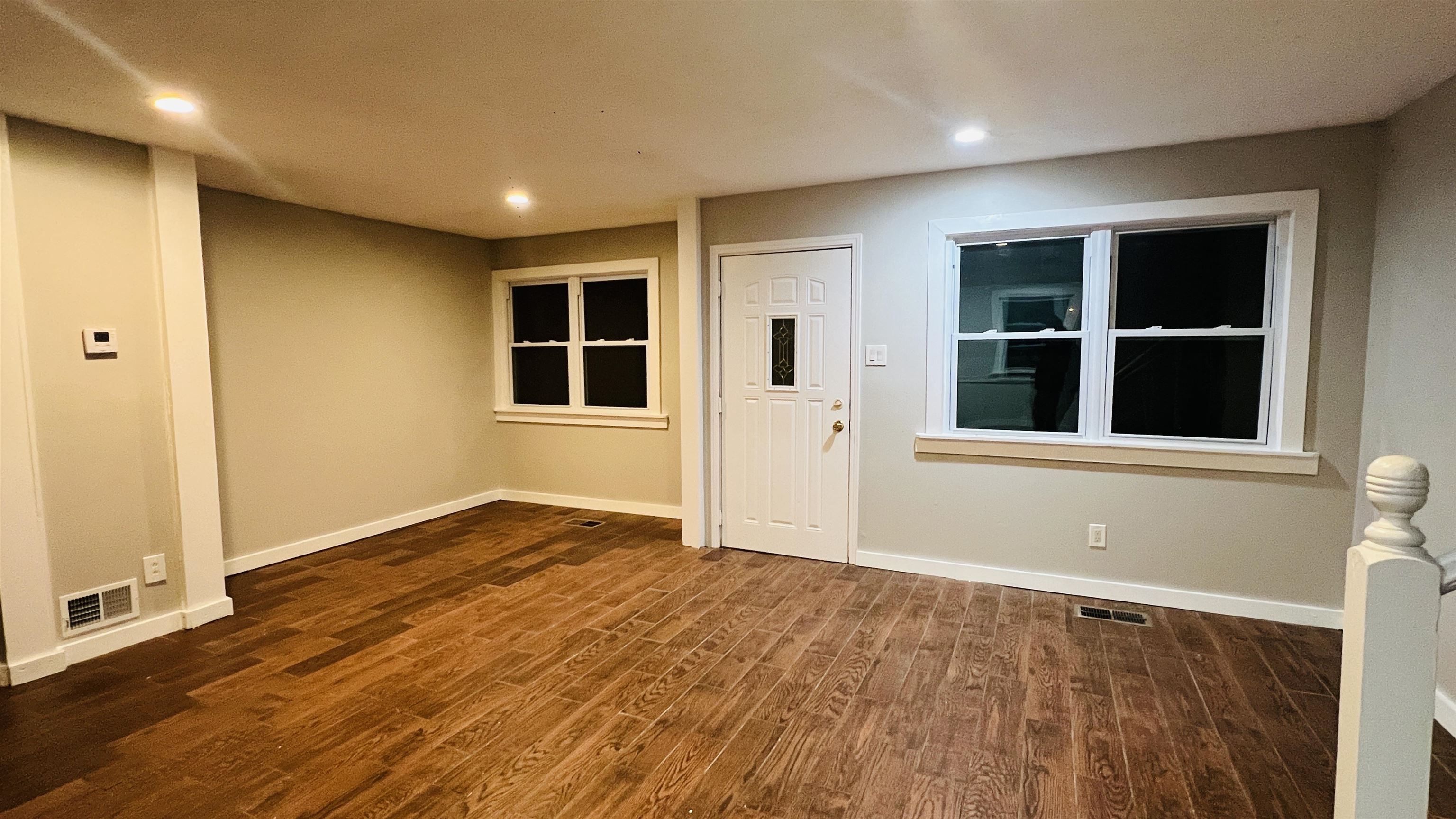 8645 Loomis Road Bartlett, TN 38002 - Photo 14 of 15 a view of an empty room with wooden floor and windows