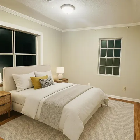 a bedroom with a bed and a window