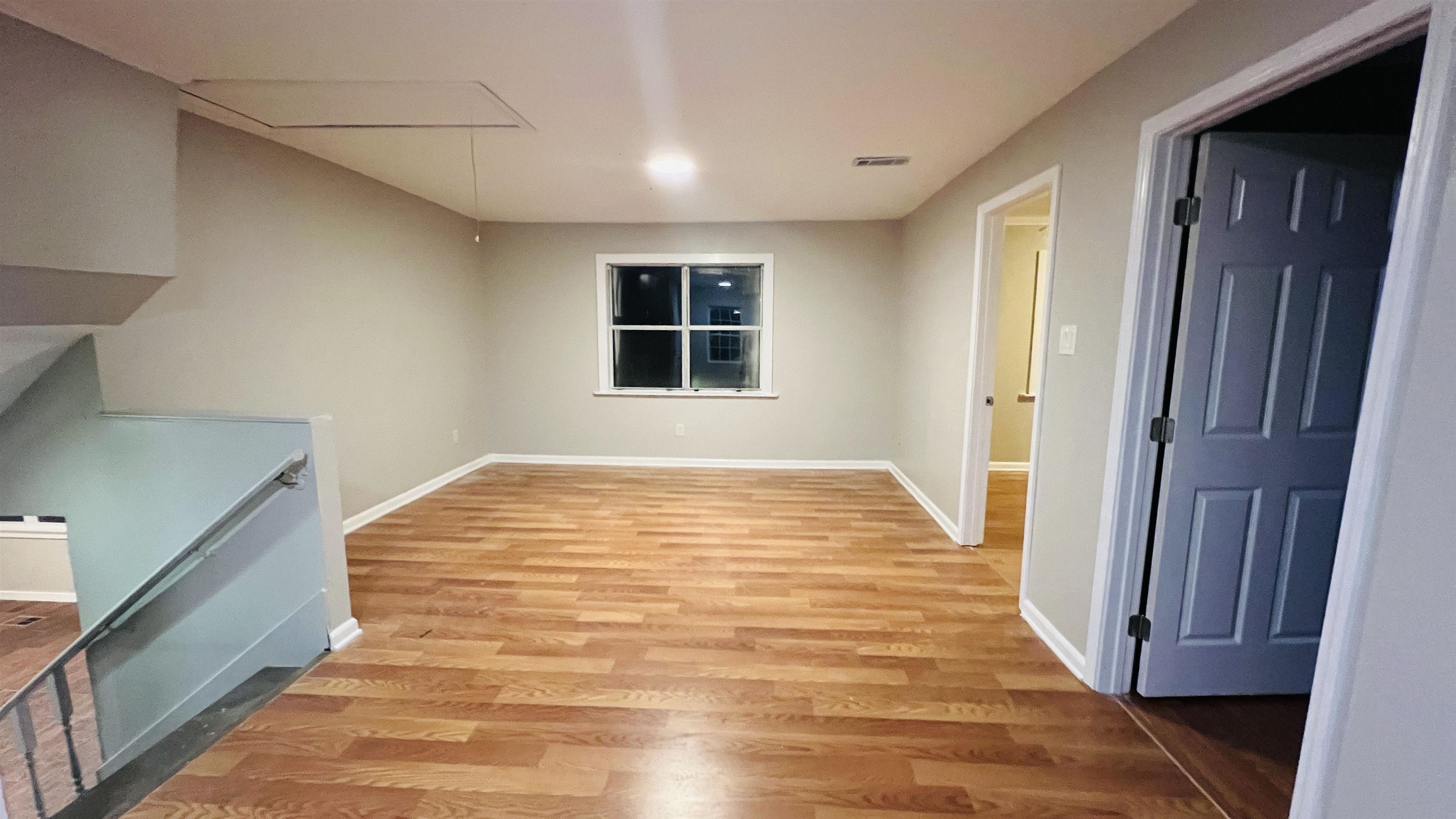 8645 Loomis Road Bartlett, TN 38002 - Photo 9 of 15 a view of an empty room with wooden floor and a window