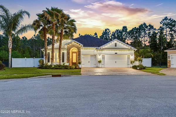 a view of house with outdoor space and parking